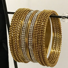 Golden bangle set with white stones