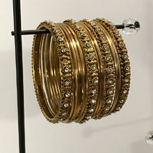 Golden bangle set with white stones